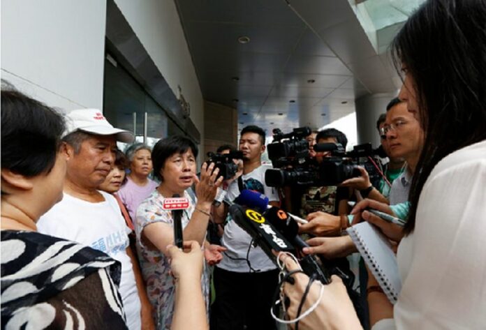 Relatives of missing Malaysia Airlines flight MH370 passengers speak outside the Malaysia Airlines office building in Beijing. Relatives of those aboard the missing plane have been waiting for more news after a piece of a plane's wing found on France's Reunion Island last week has been identified as belonging to a Boeing 777 aircraft. EPA/HOW HWEE YOUNG