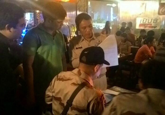 Security officers conduct an inspection at a bar in Chiang Mai province on Saturday night.