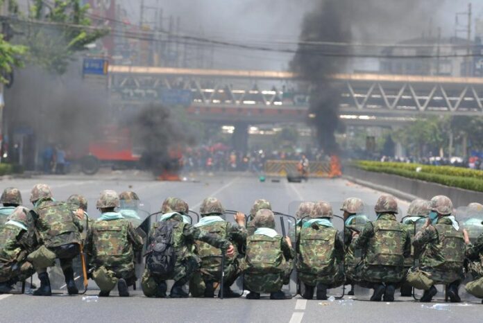 Soldiers confront Redshirt protesters on Rama IV Road in Bangkok on 14 May, 2010.