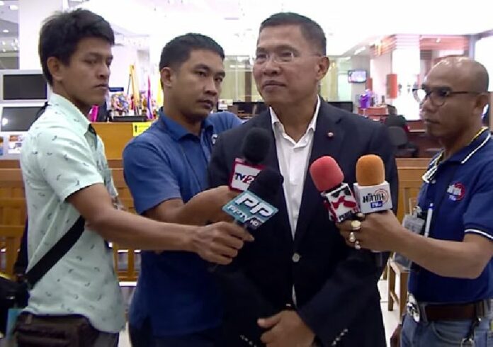 Former Pheu Thai MP Wattana Muengsuk speaks to reporters in July about his petition to get a year-old travel ban lifted. Photo: Matichon TV