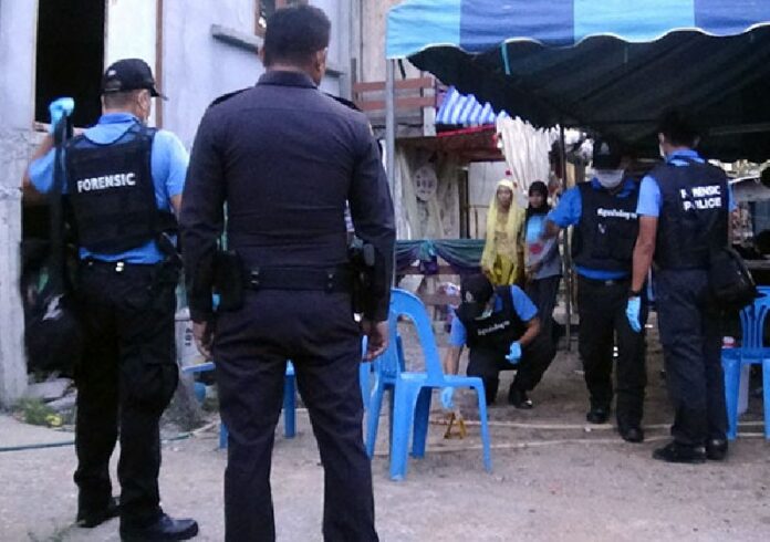 Investigators collect evidence at the scene where four gunmen shot an army ranger to death at his wedding reception yesterday in Pattani province.