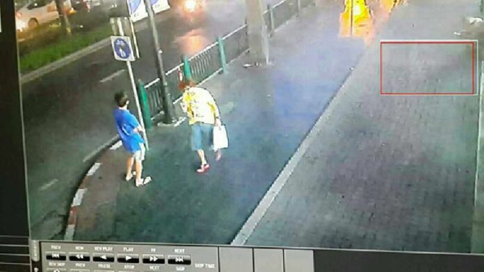 A man is seen near the site of last night's bomb attack in Bangkok with and without a backpack in images provided to the media. Police have identified him as a possible suspect and are seeking information.
