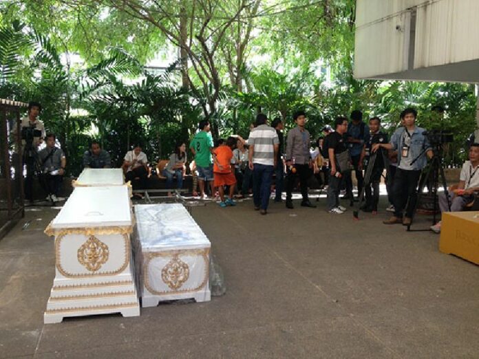 Coffins for the dead arrive today at Chulalongkorn Hospital in Bangkok.