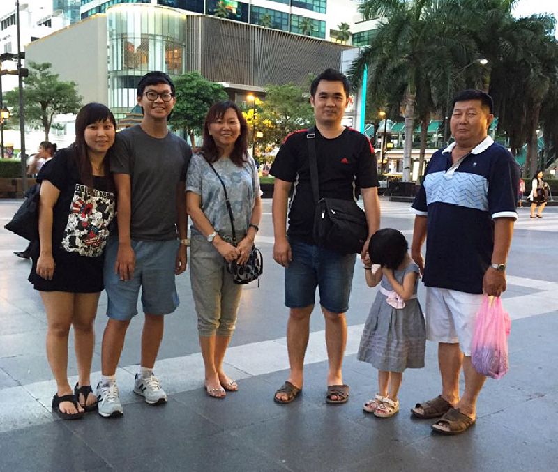 Malaysian family: From left, Ee Ling, Jai Jun, Saw Gek, Tze Siang, Jiang and Hock Guan pose for a photograph in the plaza of CentralWorld shopping mall in Bangkok, near Ratchaprasong intersection and the Erawan Shrine before the Aug. 17 blast. Five members of their family died in the attack; only Ee Ling and her father Hock Guan survived. Photo: Neoh Huey Shinn / Courtesy