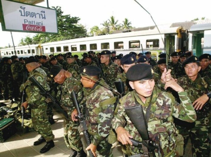 Embarking on a campaign of pacification under the government of former Prime Minister Thaksin Shinawatra, the first wave of soldiers arrive in Pattani in this May 2004 file photo.