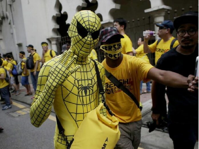 A Malaysian protester dressed in a yellow Spider-man costume poses for photographers while marching with thousands gathered in the city streets during a BERSIH (The Coalition for Free and Fair Elections) rally in Kuala Lumpur on August 29. The group wants Prime Minister Najib Razak to resign. EPA/FAZRY ISMAIL