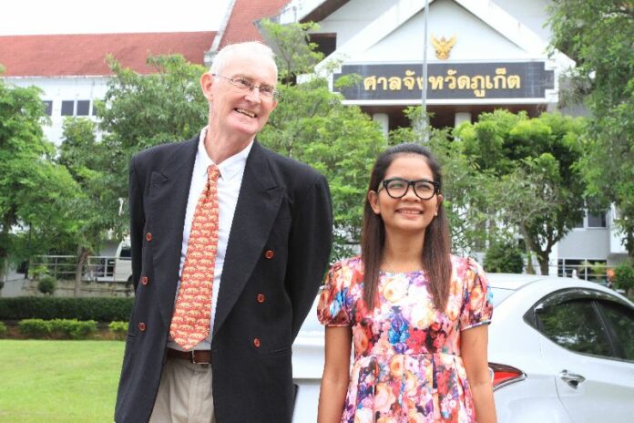 Alan Morison, left, and Chutima Sidasathian outside a Phuket provincial court where they were acquitted of all charges against them this morning.