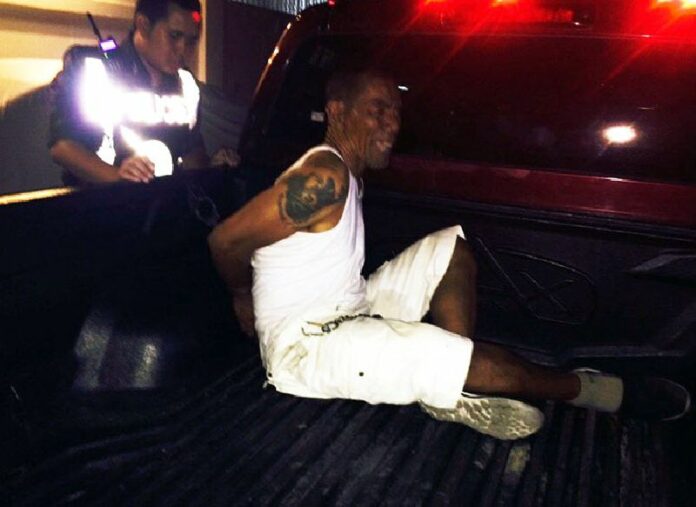 Police take away a man who only identified himself by his relationship to a higher power early this morning in South Pattaya.