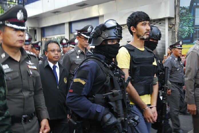 Bombing suspect Yusufu Mieraili is led through a police 're-enactment' on Sept. 9, 2015, in Bangkok.