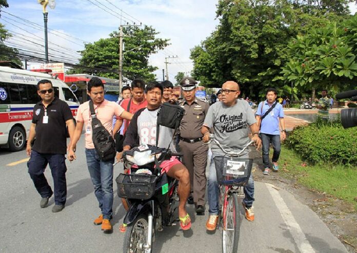 Sarawuth Poonchaem is taken on a police 're-enactment' of his crime today in Ayutthaya.