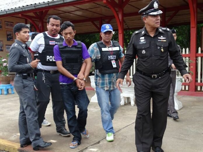 Wanchai Saengkhao 're-enacts' the crime for police in a 9 July, 2014, file photo.
