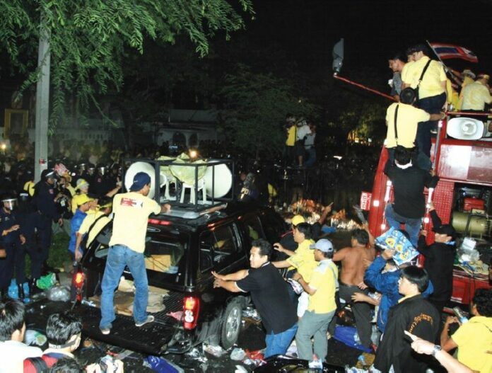 Before they became known for wearing red shirts, protesters in yellow clashed with police in front of the home of Gen. Prem Tinsulanonda in this July 2008 file photo.