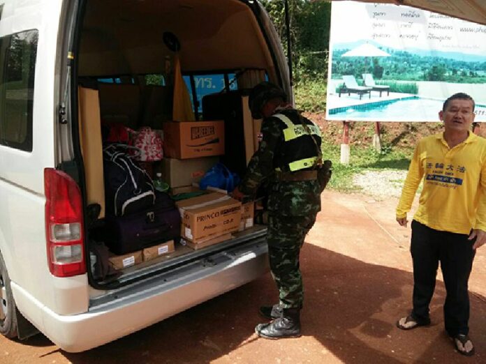 A soldier looks today looks through a van being used by Wattana Anuraksrithong and five other Falun Gong followers in Mae Hong Son province. They were briefly detained and had their pamphlets seized by soldiers concerned about their criticism of China.