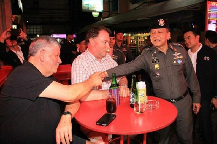 Police Lt. Gen. Prawuth Thawornsiri and other officers patrol Soi Cowboy in Bangkok to assure foreigners of their safety two days after a deadly bomb attack on 19 Aug., 2015.<br />