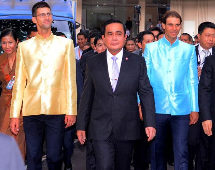 Novak Djokovic, 28 of Serbia, junta chairman Gen. Prayuth Chan-ocha and 29-year-old Rafael Nadal of Spain pose for photographers this morning at Bangkok's Government House.