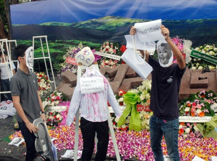Activists interpret the events of 6 Oct. 1976 massacre by staging a mock execution.