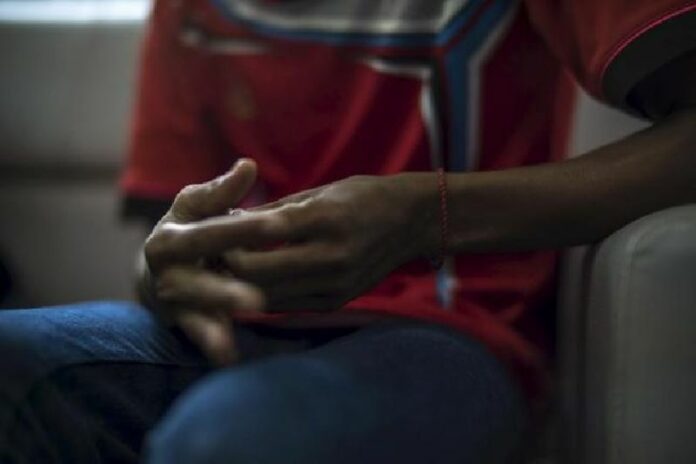 The hands of a Rohingya victim of trafficking are seen as he listens to questions during an interview with the Thomson Reuters Foundation at a temporary shelter in Hat Yai, Songkhla province on Sept. 22. Photo: Reuters / Athit Perawongmetha