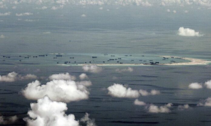 An artificial island under construction in the Spratly Islands as seen in a May 2015 file photo. Photo: EPA pool / Ritchie B. Tongo