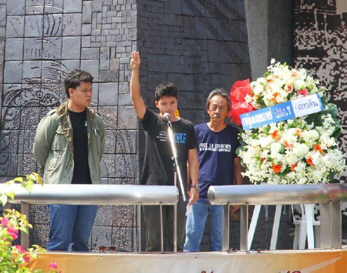 An activist from the Dao Din pro-democracy group flashes the 'three-finger salute' adopted by activists from the 'Hunger Games' films at a ceremony today marking the 42nd anniversary of the uprising on October 14, 1973.