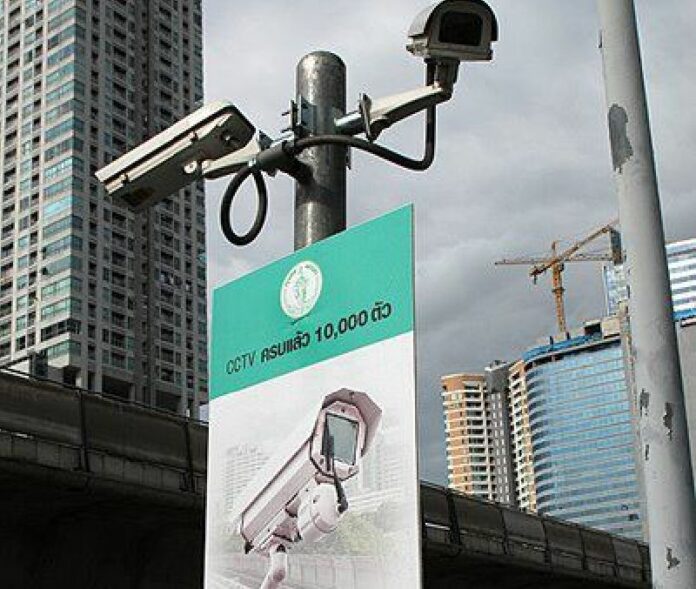 A sign below a Bangkok security camera in 2011 announces that 10,000 CCTV cameras had been installed. Photo: Pantip