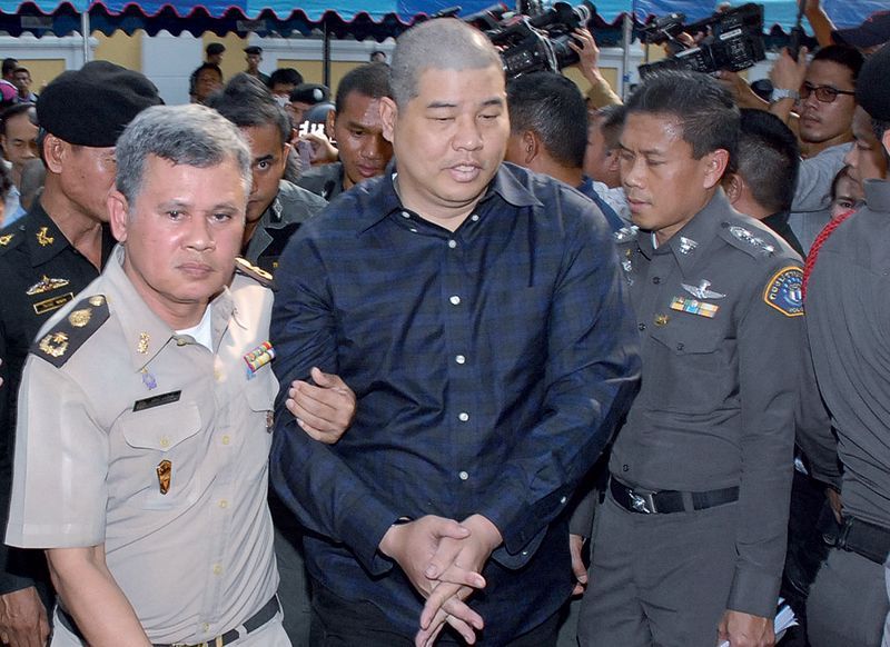 Police Maj. Prakrom Warunprapha, at center, was remanded into custody Wednesday at a military court in Bangkok. He committed suicide Friday night, officials said today.