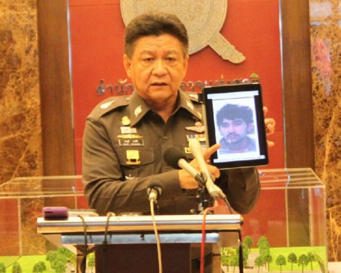 Police Maj. Gen. Prawuth Thawornsiri displays a photo of bombing suspect Yusufu Mieraili in Bangkok on Sept. 3, the day he was taken into Thai custody.