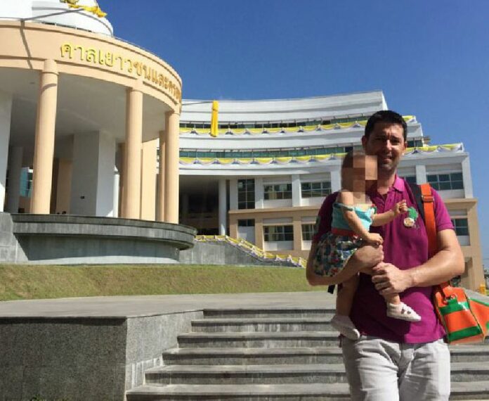 Manuel Santos carries baby Carmen out of the Central Juvenile and Family Court today in Bangkok. Photo: @tonkumchoke / Twitter