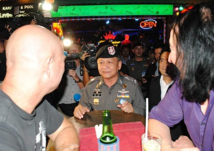 Police Gen. Prawuth Thawornsiri and other officers patrol Soi Cowboy on Aug. 19 in Bangkok to assure foreigners of their safety two days after a deadly bomb attack.