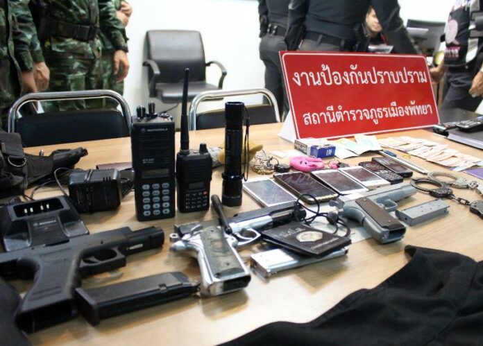 Fake guns and other evidence confiscated in the raid were displayed to reporters on Sunday night.