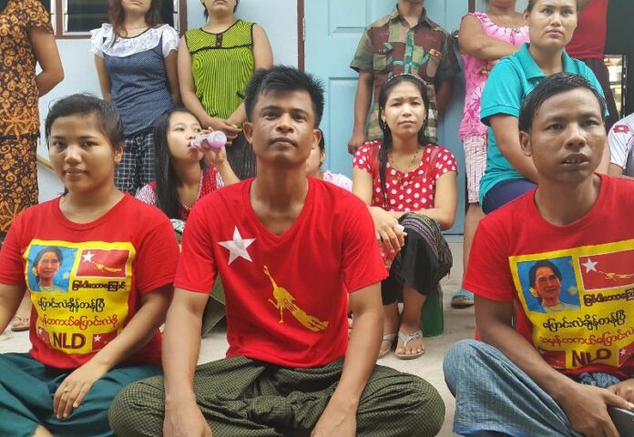 Myanmar workers in southwest metro Bangkok watch coverage Sunday of the election back home.