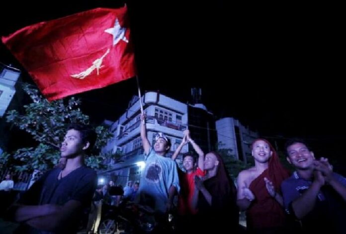Supporters of opposition leader Aung San Suu Kyi celebrate at the National League for Democracy offices Monday, one day after historic general elections were held. Photo: Reuters / Olivia Harris