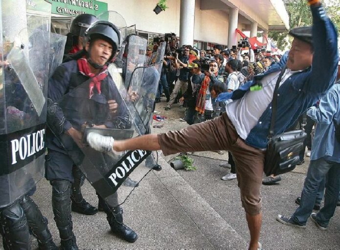 Anti-government protesters clash with riot police Dec. 25, 2013, at Thai-Japanese Stadium in Bangkok.