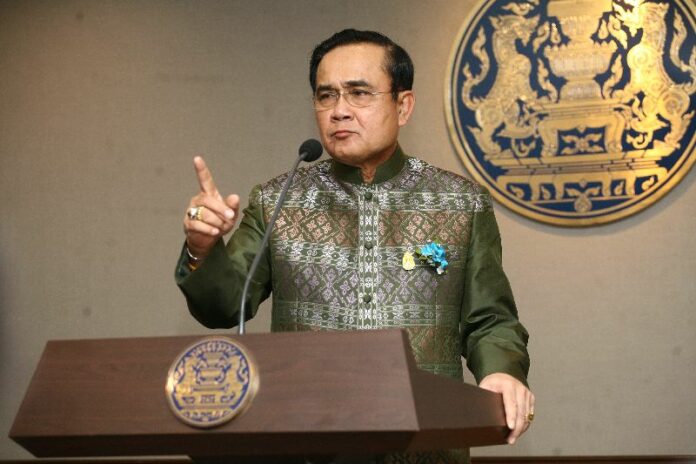 Junta chairman Prayuth Chan-ocha speaks to reporters Nov. 10 at Government House in Bangkok.