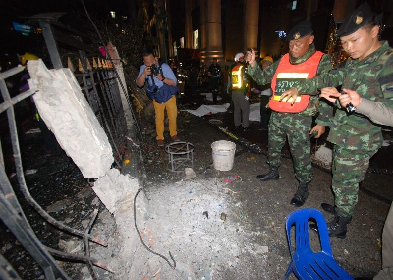 Security officers inspect the blast site at Erawan Shrine on Aug. 17, 2015, in Bangkok.