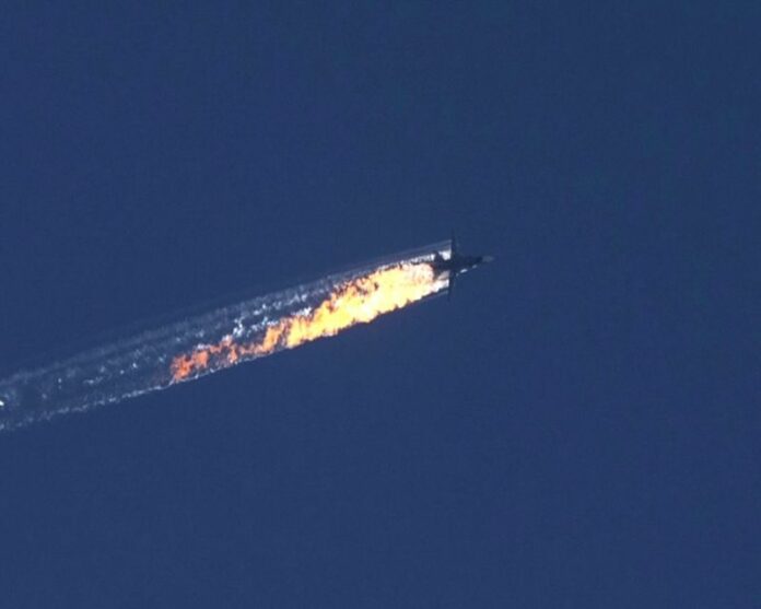 A still image from video footage Tuesday on HaberTurk TV shows a burning trail as a plane comes down after being shot down near the Turkish-Syrian border, over north Syria. Photo: EPA / Haberturk TV