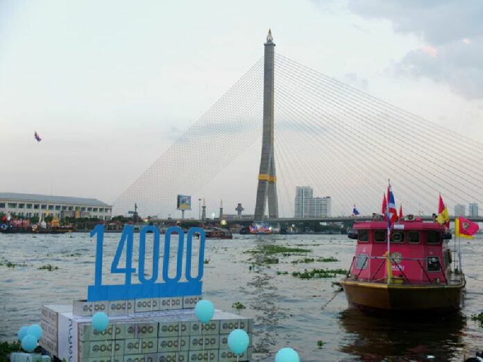 ‘Friends of the River’ send a custom ‘krathong’ floating into the Chao Phraya river Wednesday in Bangkok to represent 14 billion baht the junta wants to spend on a project they deem ugly, wasteful and poorly conceived.