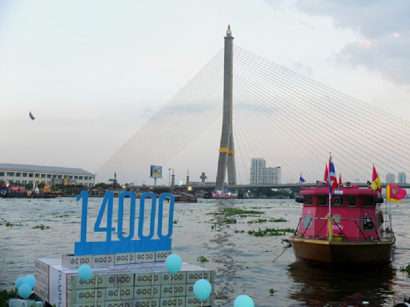 ‘Friends of the River’ send a custom ‘krathong’ floating into the Chao Phraya river Wednesday in Bangkok to represent 14 billion baht the junta wants to spend on a project they deem ugly, wasteful and poorly conceived.
