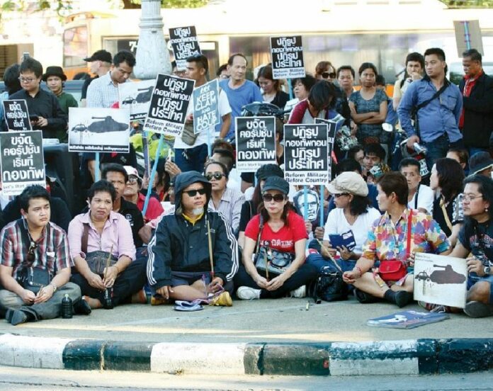 Pansak Srithep, third from left in front, members of Resistant Citizens and supporters demonstrate Oct. 31 on Ratchadamnoen Avenue in Bangkok.