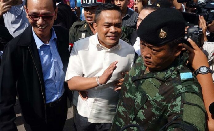 Redshirt leader Jatuporn Prompan is taken into military custody while talking to reporters Monday morning in Samut Sakhon province.