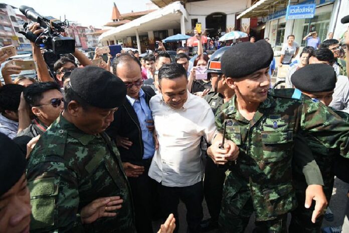 Jatuporn Prompan is led away from a news conference Monday morning southwest of Bangkok in Samut Sakhon province.