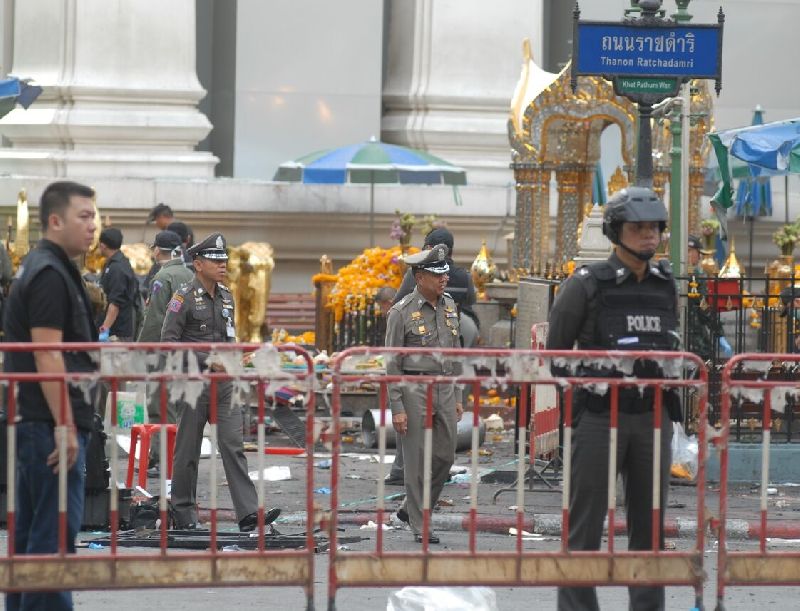 Investigators comb the Erawan Shrine for evidence on Aug. 18, the day after a bomb killed 20 people there, mostly tourists.