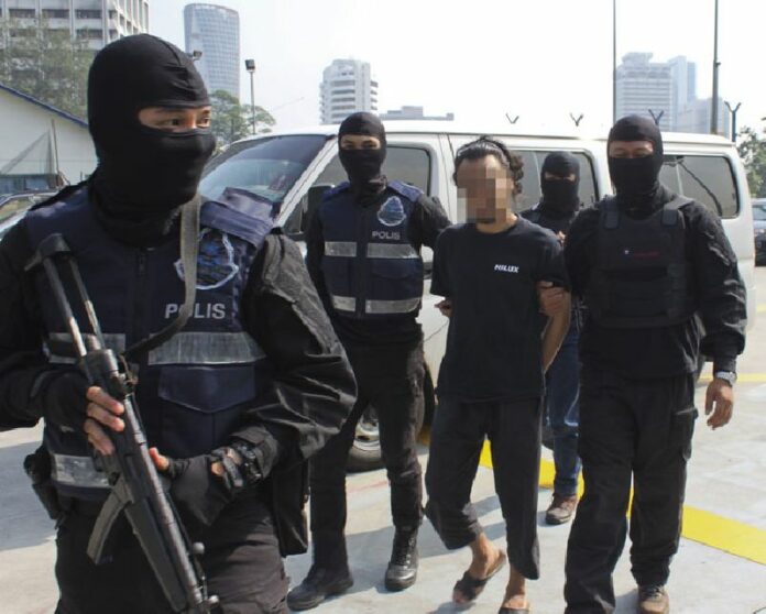 Malaysia's Special Branch Counter Terrorism Division officers arrest suspected Islamic militants in Kuala Lumpur, Malaysia, in a July 9 file photo. Photo: EPA / Royal Malaysian Police