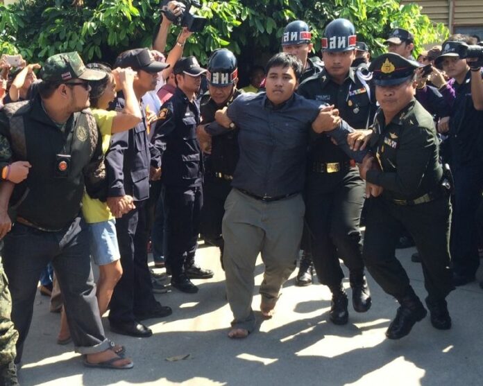 Soldiers detain activist Sirawith Seritiwat Monday in Ratchaburi province.