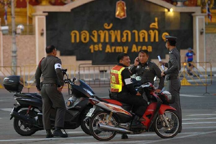 Police on Sunday patrol the planned route of the Bike for Dad event in Bangkok.