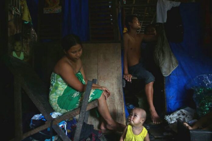 A family at their home in a slum area in Hlaing Tharyar, a sprawling township to the north of Yangon. Photo: Hkun Latt / Myanmar Now