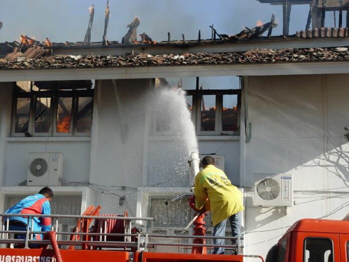In this 19 May, 2010, file photo, firefighters combat the blaze at Ubon Ratchathani City Hall after a group of Redshirt protesters set it on fire.