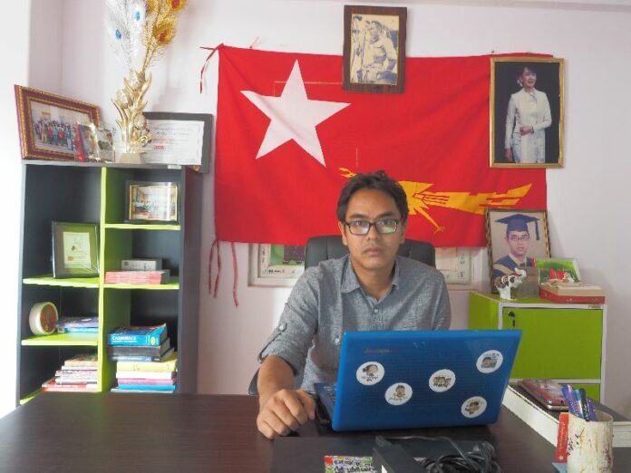 Nay Phone Latt, National League for Democracy MP-elect for Yangon Region parliament, works in his office in early December. Photo: Connor Mcdonald / Myanmar Now