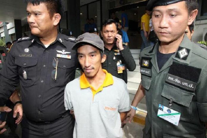 Thanet Anantawong, 25, is escorted outside a military court Dec. 18 in Bangkok.