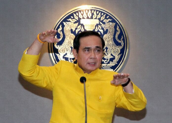 Junta chairman Prayuth Chan-ocha speaks to reporters today at Government House in Bangkok.