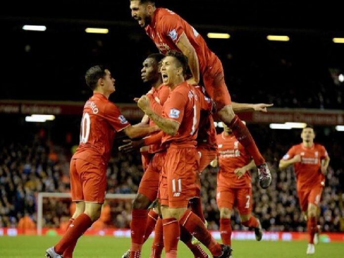 Liverpool players celebrate with Christian Benteke after he scores in a 1-0 defeat of Leicester City in the English Premier League match at Anfield, Liverpool Saturday. Photo: Peter Dowell / EPA